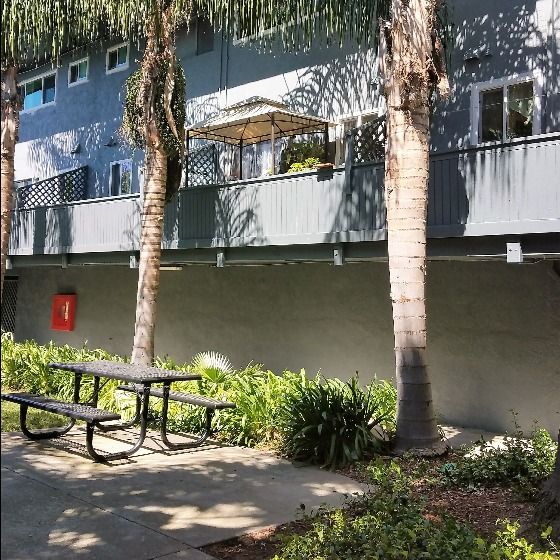 Converge Townhouses two story back terraces, features sliding glass door leading to upper balcony and landscaped picnic area below.