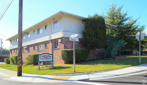 Two-story brick and stucco apartment building, labeled 