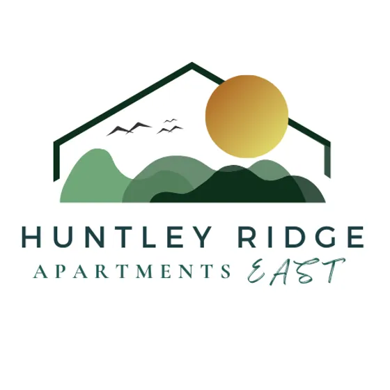 Logo for Huntley Ridge Apartments East featuring a minimalist outline of a house roof above layered green hills with a golden sun rising on the right side. The text 'HUNTLEY RIDGE' appears in bold, uppercase letters, with 'APARTMENTS EAST' written below in a modern serif and script font.