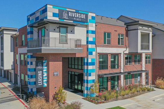 Contemporary apartment building with colorful accents and spacious balconies at Riverside Place.