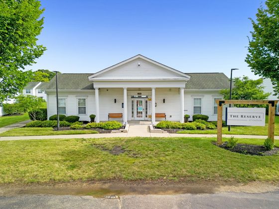Charming community building at The Reserve at Easton, featuring classic white columns and well-maintained landscaping.