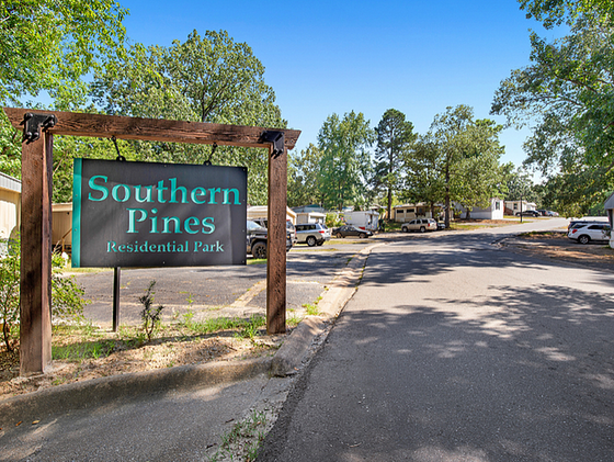 Inviting Southern Pines Residential Park entrance surrounded by lush greenery and welcoming atmosphere.