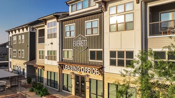 Contemporary apartment building with stylish facade and welcoming leasing office entrance.