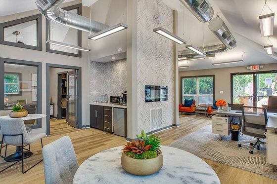 Leasing office with hardwood style flooring, table and chairs, and desk