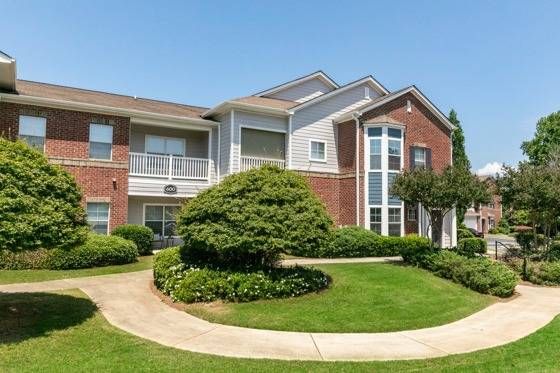 Building exterior with lush landscaping and side walk