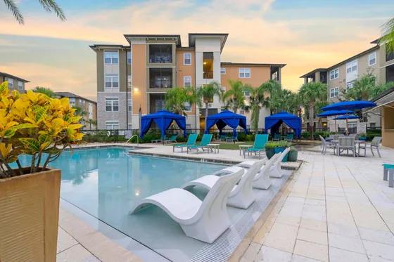 Pool view with lounge seating and umbrellas