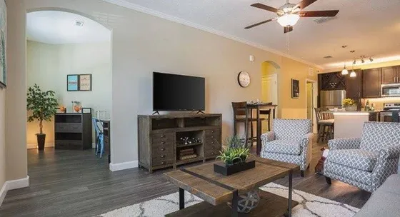 Open living room and kitchen concept with arched doorways and wood-like flooring
