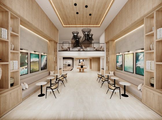 Luxurious open-concept lounge with modern art, elegant lighting, and chic seating in a sophisticated apartment complex.