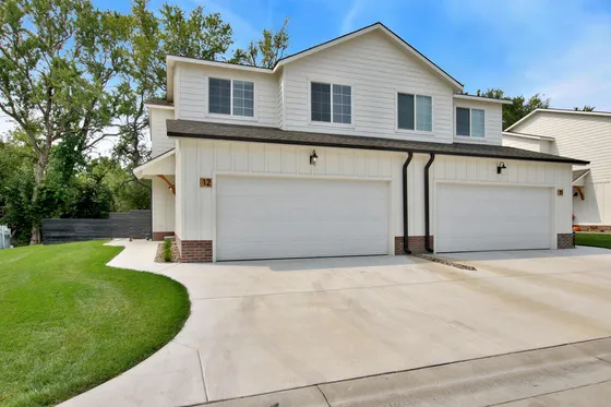 Charming duplex with modern design, featuring spacious garages and well-maintained landscaping.