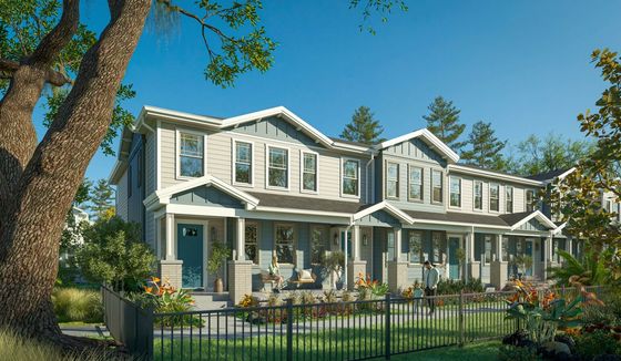 Charming townhomes with stylish exteriors, lush landscaping, and vibrant garden views, perfect for modern living.