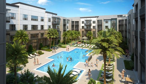 Modern apartment complex with a resort-style swimming pool and lush palm trees.