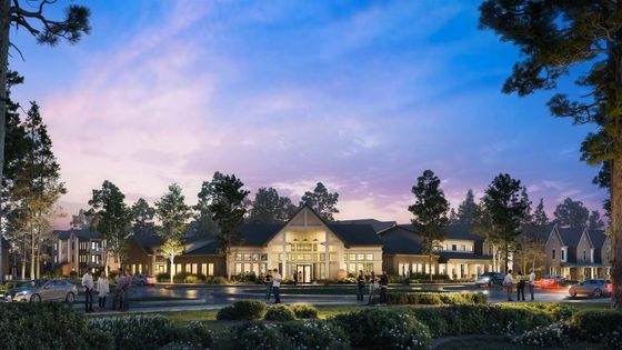 Stunning evening view of a luxurious residential complex surrounded by lush greenery and soft ambient lighting, with people leisurely enjoying the serene atmosphere.