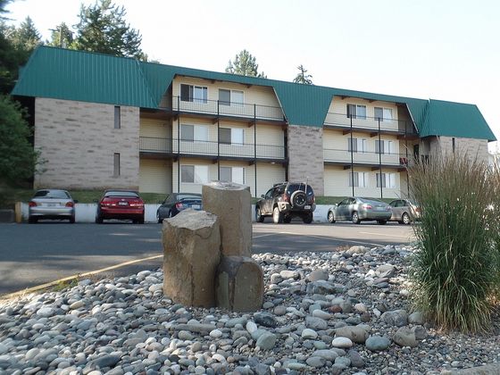 Charming three-story apartment building surrounded by lush greenery and ample parking space, located at 1205 Valleyford.