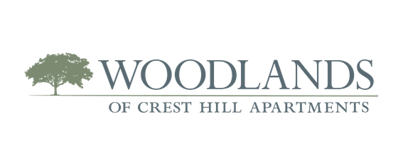 Elegant logo for Woodlands of Crest Hill Apartments featuring a classic tree design.