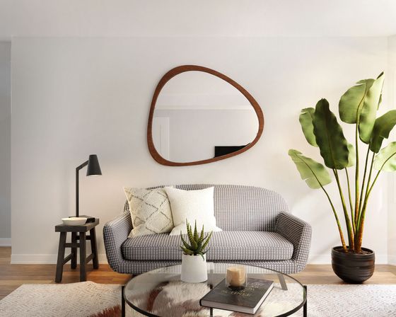 living room with grey sofa, a coffee table and a side table with a bowl and lamp