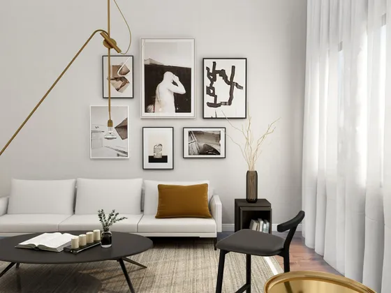 living room with white sofa round coffee table and area rug along with a gallery wall in the back