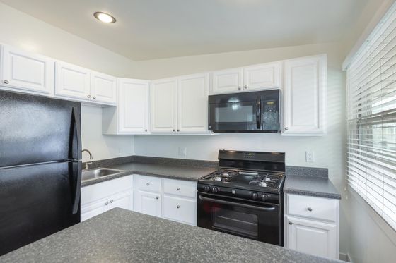 kitchen with black appliances at Elan - Beachcomber La Jolla
