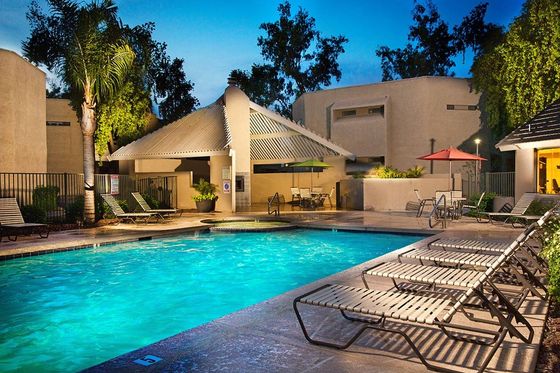 lit pool with lounge chairs at silver creek at night