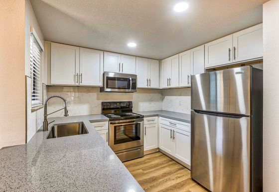 kitchen with granite countertops and stainless steel appliances and at redfield ridge apartments