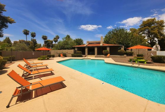 Community pool along with colorful furniture at resident's use.