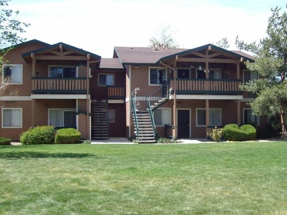 two story apartment building with grassy area in front at brooktree apartments