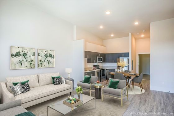 virtually staged living room with beige sofa and two grey chairs at rogers landing