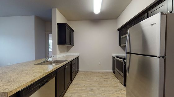 stainless steel appliances and black cabinets at trillium woods