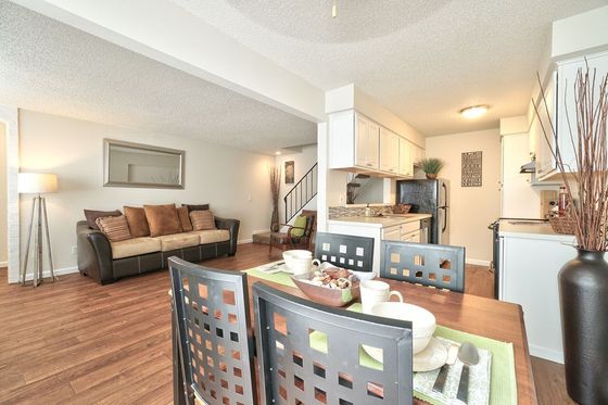 kitchen and living room with faux wood flooring and stainless steel appliances