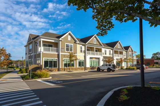 Charming modern apartment building with inviting balconies and beautifully landscaped surroundings.