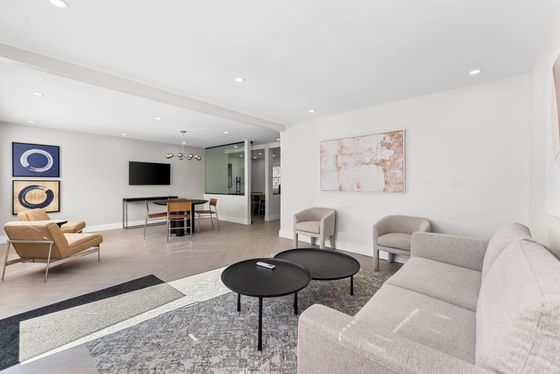 Elegantly designed modern leasing office with plush seating, chic decor, and ample natural light