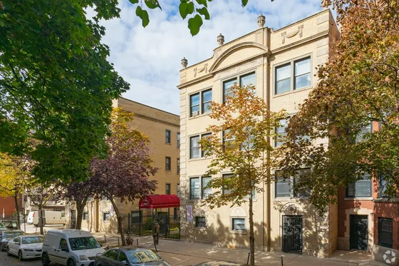 520-28 West Surf a fifty one unit three story yellow brick courtyard building on a tree lined street in Lakeview.