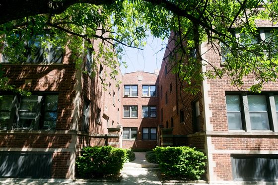3610 West Sunnyside a twenty four unit red brick courtyard building with mature trees in Albany Park.