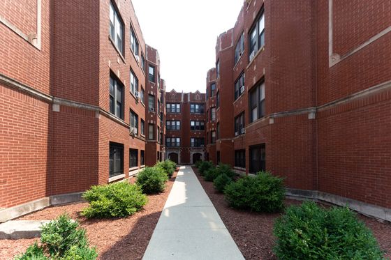 3625 West Dickens a sixty unit red brick courtyard building with landscaped grounds.
