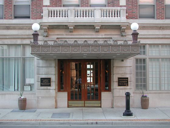 North Island Apartments an historic main entrance in limestone and wood to a fifty seven unit senior building in Aurora Illinois..