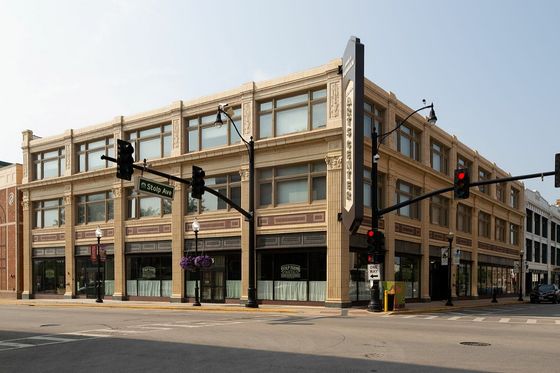 Three story apartment building with retail first floor and 2 residential floors.