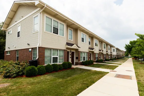 Two story brick and wood sided townhouse style apartments in North Lawndale.
