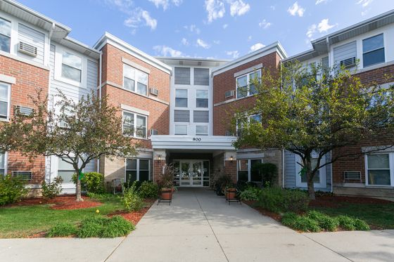Brick and gray sided suburban 3 story apartment building entrace