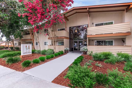 Ladera Woods apartment entrance sign with trees and address at 4401 Central Avenue.
