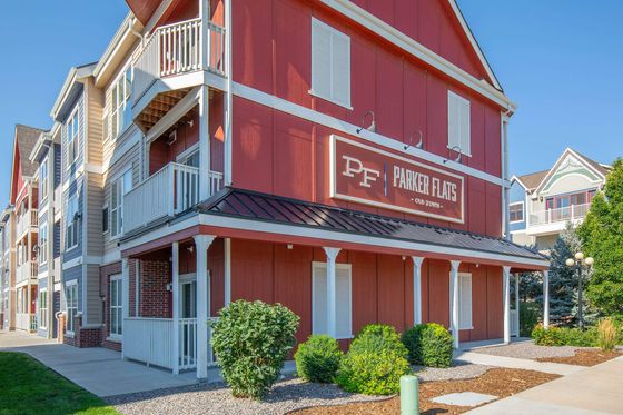 Parker Flats at Old Town Red Building Exterior with Panel Signage