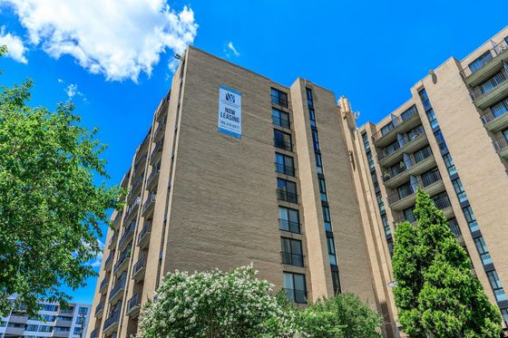 Whitestone at Landmark Brick High Rise Building Exterior with Now Leasing Banner