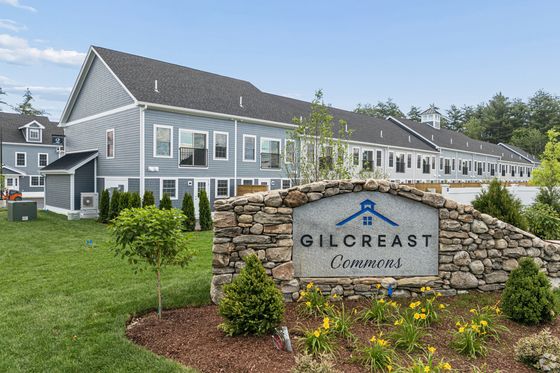 Charming apartment complex exterior, featuring modern architecture and well-maintained landscaping at Gilcreast Commons.