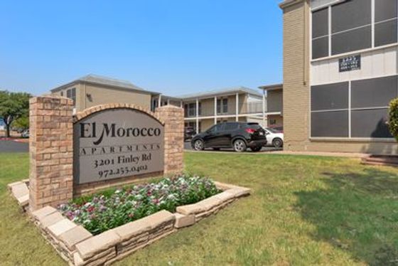 Inviting exterior of El Morocco Apartments with a well-maintained garden and convenient parking area.