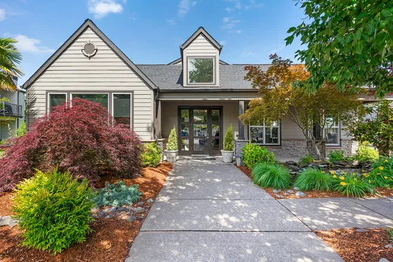 Chase Village's beautiful modern cottage front with lush landscaping and inviting entrance.