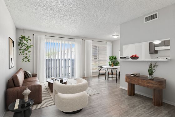 Bright and inviting living room with elegant furniture, stylish decor, and large windows letting in natural light.