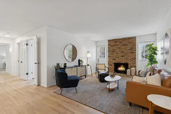 Inviting living room with modern decor, cozy fireplace, and stylish furniture, perfect for relaxation and gatherings.