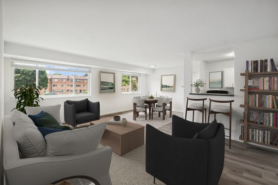 Bright and inviting living area with stylish furniture, open dining space, and large windows offering scenic views.