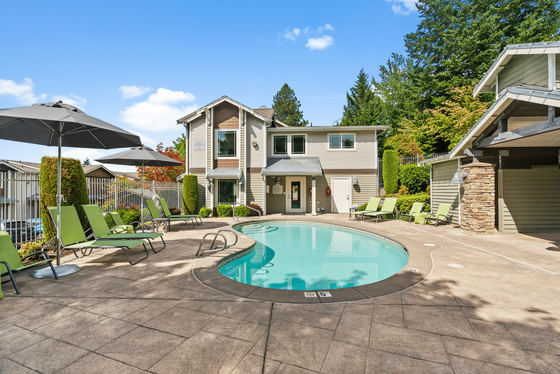 Charming residential complex with inviting pool, modern architecture, and lush greenery, perfect for relaxation.