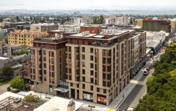 Stunning aerial view of a modern urban apartment complex with elegant brick facade, surrounded by vibrant cityscape and lush greenery, offering breathtaking skyline vistas.