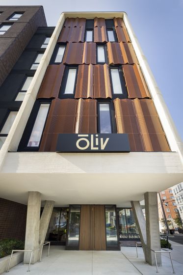 Modern apartment building exterior with unique architectural design and stylish facade.