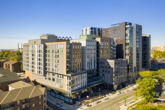 Modern urban apartment complex with sleek design, offering luxury living spaces and vibrant city views.